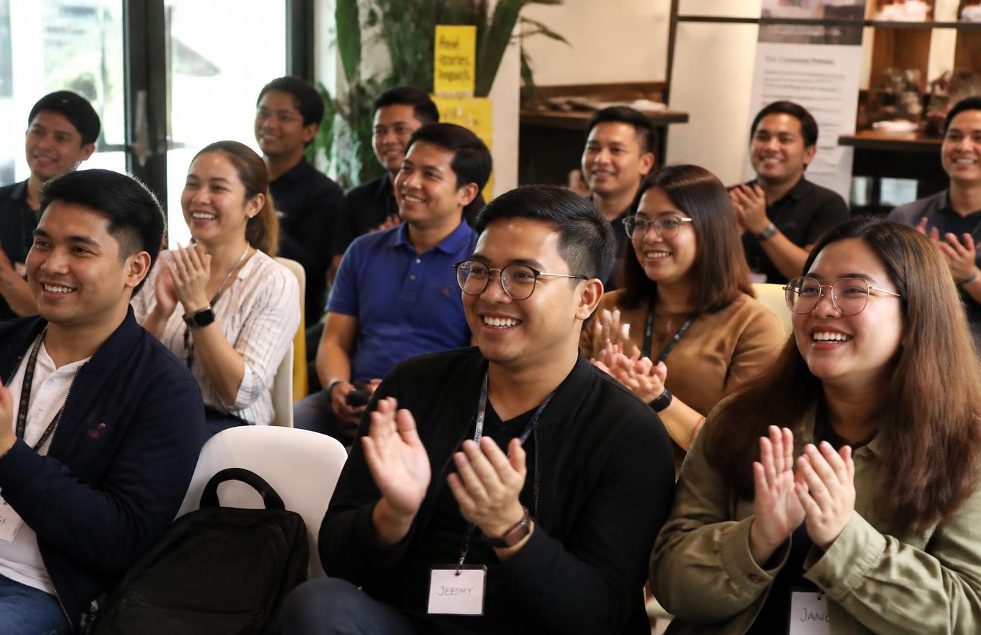 Filipino professionals applauding at a VA Heroes PH community event